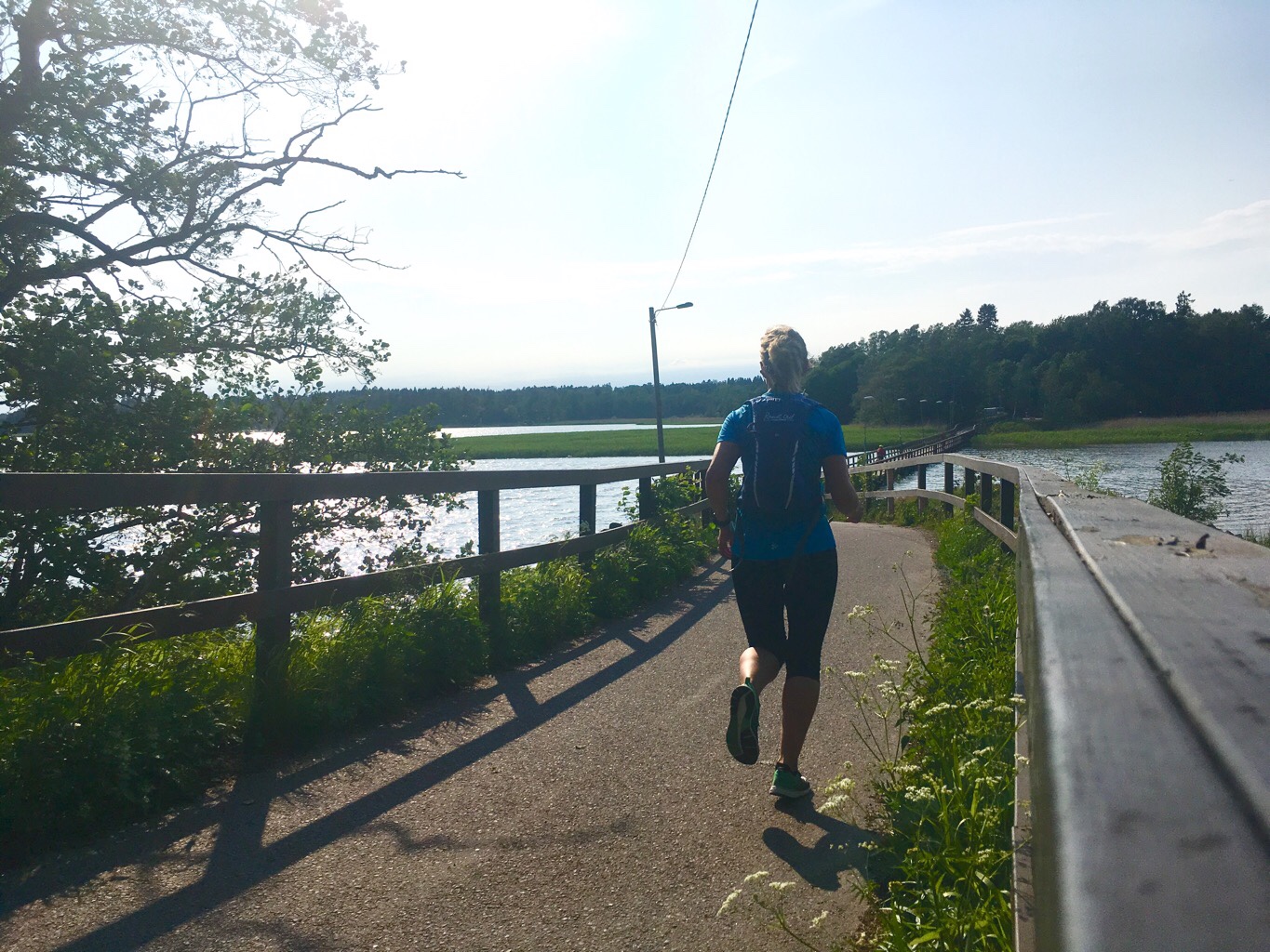 Kuva, jossa juoksija sillalla.