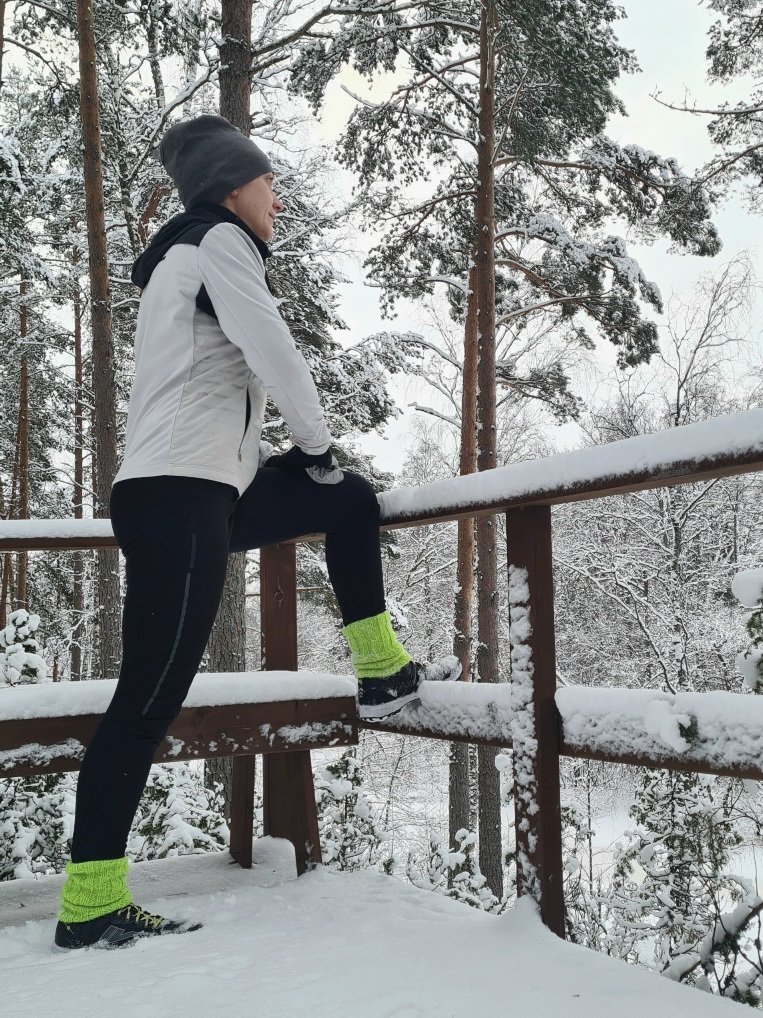 juoksija seisoo kaiteen vieressa ja katselee maisemia