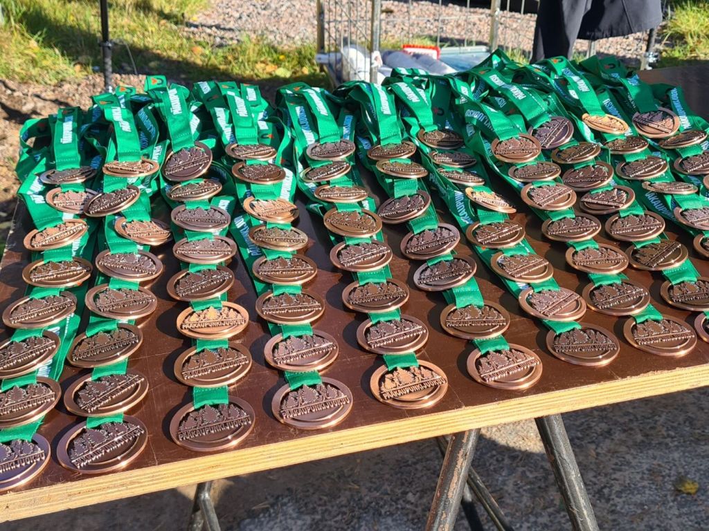 participant medals on a row on a table